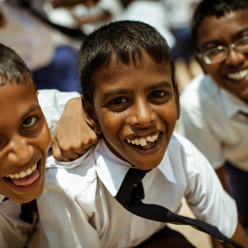 School children dressed in uniform have fun and play in the schoolyard. Wadduwa, Sri-Lanka.